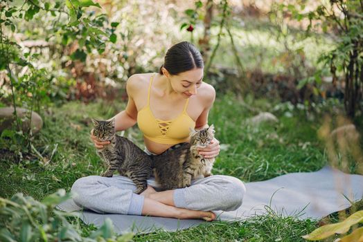 Girl in a summer park. Woman in a yellow top. Lady with a cat.