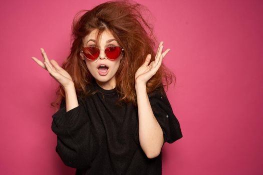 beautiful woman fashionable hairstyle sunglasses posing pink background. High quality photo