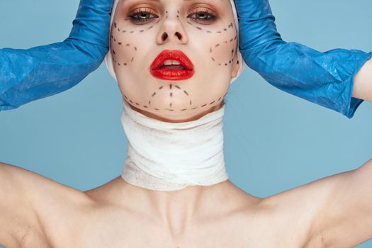 female patient Red lips plastic surgery operation bare shoulders blue background. High quality photo