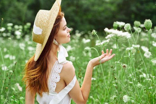 Woman with hat white dress flowers nature relaxation. High quality photo