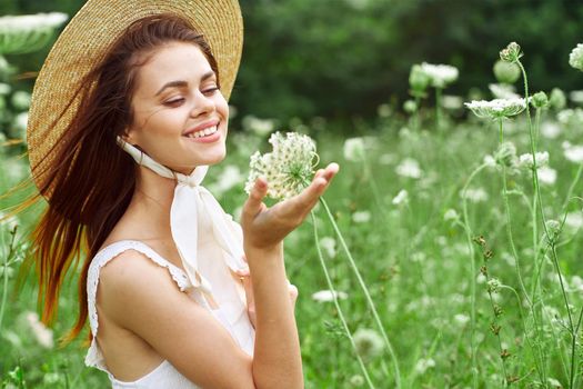 Woman in white dress and hat on nature flowers freedom. High quality photo