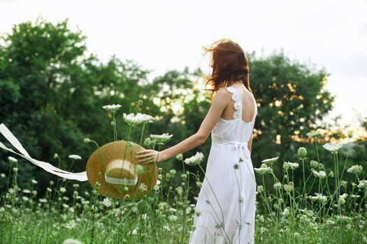 Woman in white dress flowers freedom walk fresh air. High quality photo