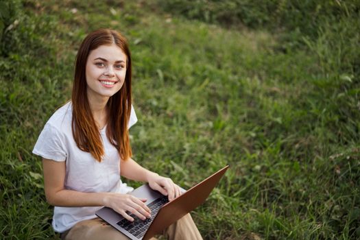 cheerful woman outdoors laptops communication internet. High quality photo