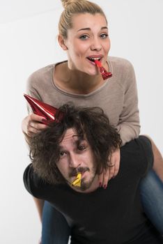 happy young romantic  couple in love  celebrating and blowing confetti decorations at new year and charismas  party