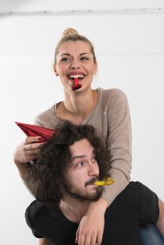 happy young romantic  couple in love  celebrating and blowing confetti decorations at new year and charismas  party