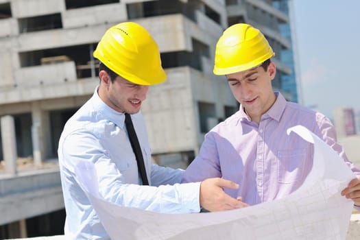 Team of architects people in group  on construciton site check documents and business workflow