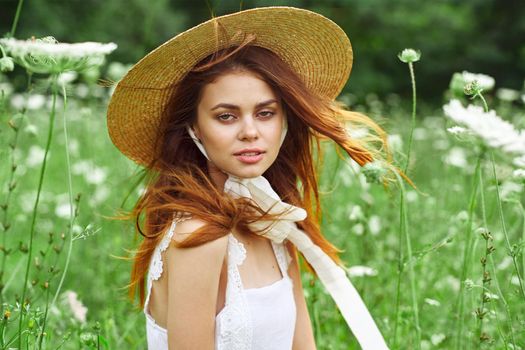 pretty woman with hat nature field flowers fresh air. High quality photo