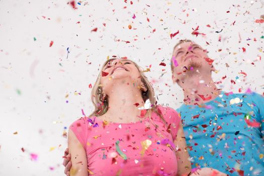 young romantic  couple in love  celebrating and blowing confetti decorations