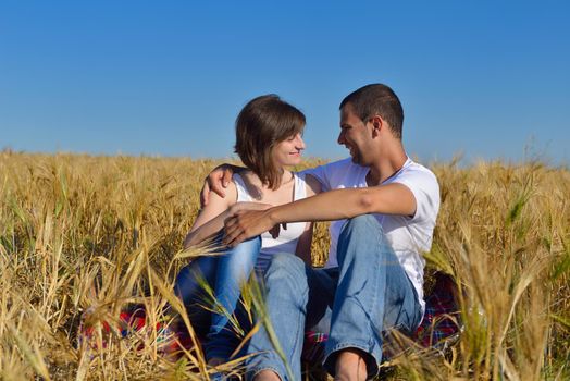 happy young couple in love have romance and fun at wheat field in summer