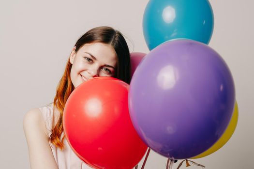 cheerful woman in a dress of colorful balloons. High quality photo