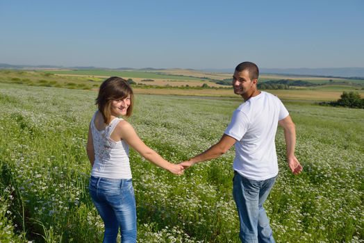 happy young couple in love have romance and fun at wheat field in summer