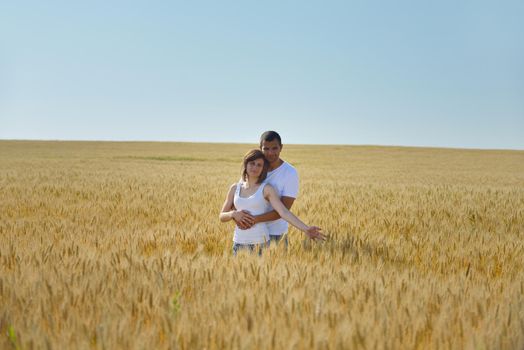 happy young couple in love have romance and fun at wheat field in summer