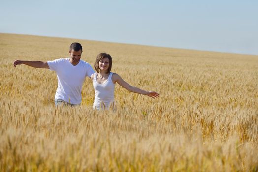 happy young couple in love have romance and fun at wheat field in summer