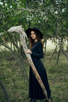 woman in black suit Witch in a fantasy forest. High quality photo