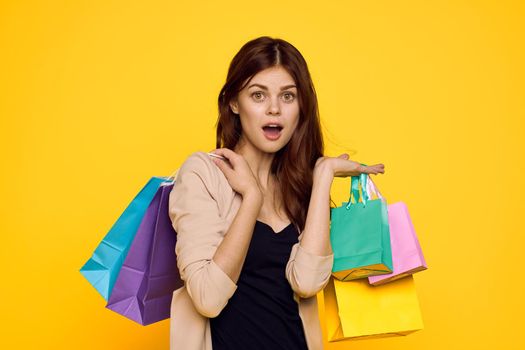 smiling woman shopping entertainment lifestyle yellow background. High quality photo