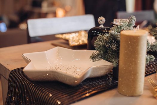 Serving table with festive dishes and candles. New Year eve concept