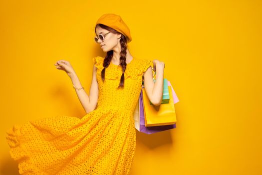 glamorous woman in a yellow hat Shopaholic fashion style yellow background. High quality photo