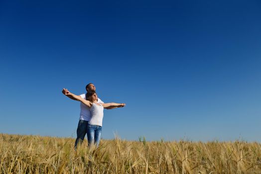 happy young couple in love have romance and fun at wheat field in summer