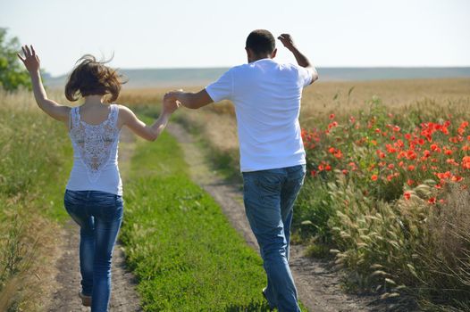 happy young couple in love have romance and fun at wheat field in summer