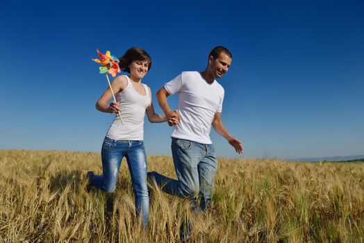 happy young couple in love have romance and fun at wheat field in summer