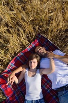 happy young couple in love have romance and fun at wheat field in summer