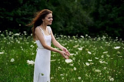 pretty woman in white dress field flowers freedom nature. High quality photo