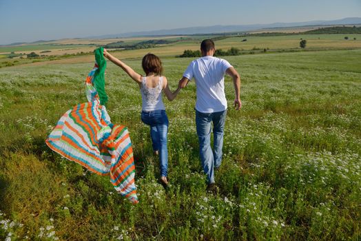 happy young couple in love have romance and fun at wheat field in summer