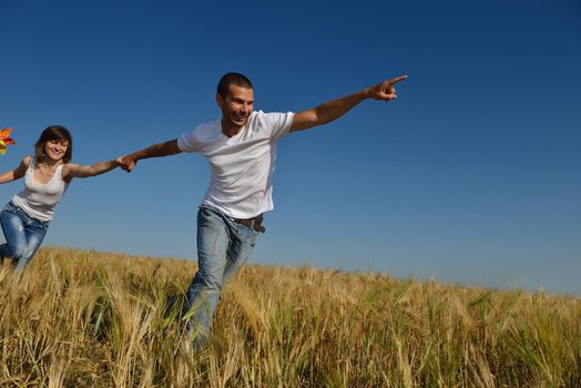 happy young couple in love have romance and fun at wheat field in summer