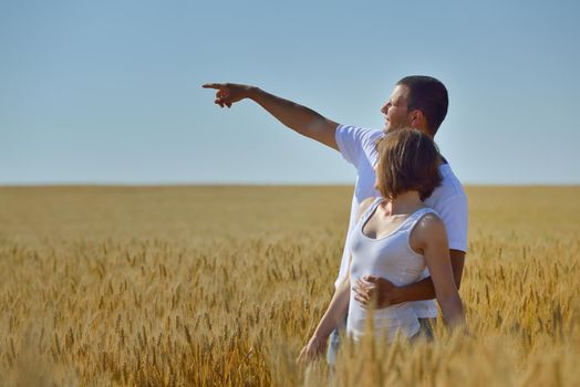 happy young couple in love have romance and fun at wheat field in summer