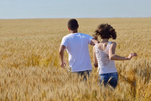 happy young couple in love have romance and fun at wheat field in summer