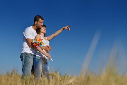 happy young couple in love have romance and fun at wheat field in summer