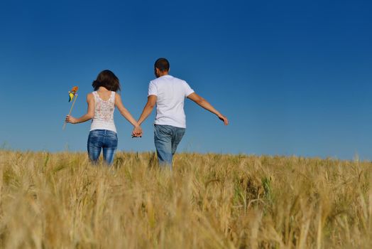 happy young couple in love have romance and fun at wheat field in summer