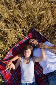 happy young couple in love have romance and fun at wheat field in summer