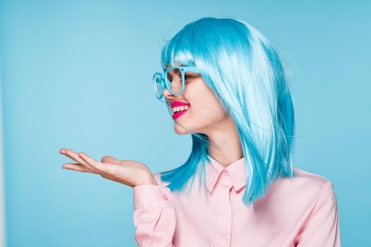 pretty woman in pink shirt purple wig glasses red lips. High quality photo