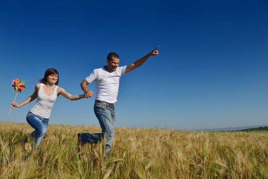 happy young couple in love have romance and fun at wheat field in summer