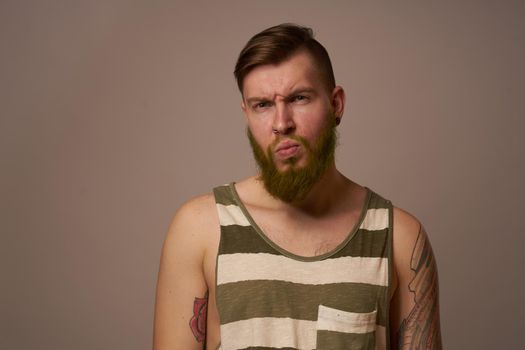 national bearded man in a striped jersey hipster tattoos on his arms. High quality photo