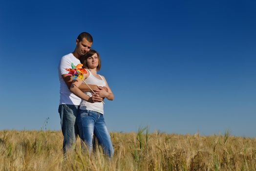 happy young couple in love have romance and fun at wheat field in summer