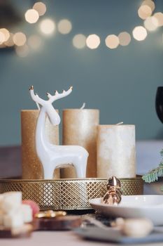 Christmas table in the living room with the objects of holiday decor. New Year eve concept