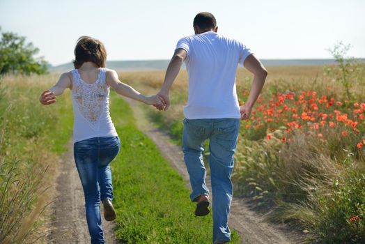 happy young couple in love have romance and fun at wheat field in summer