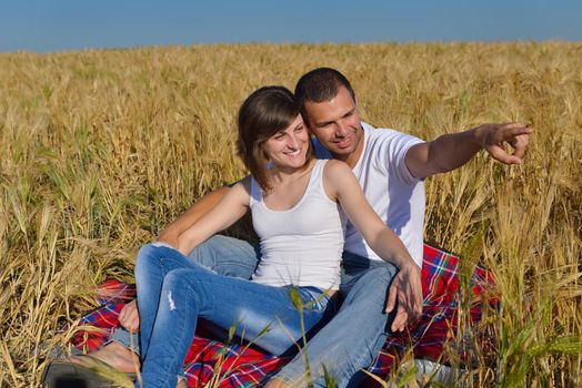 happy young couple in love have romance and fun at wheat field in summer