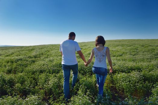 happy young couple in love have romance and fun at wheat field in summer