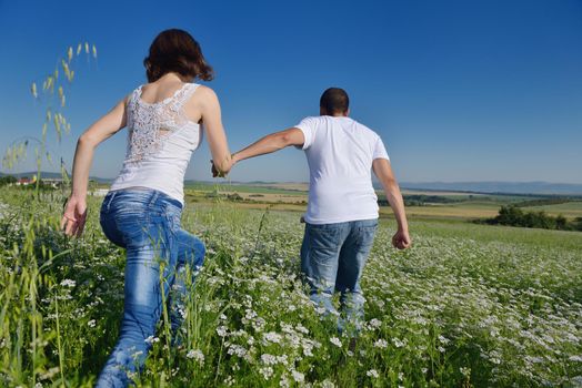 happy young couple in love have romance and fun at wheat field in summer