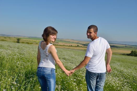 happy young couple in love have romance and fun at wheat field in summer