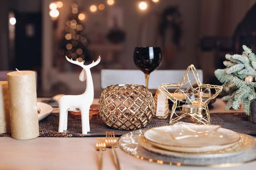 Christmas table in the living room with the objects of holiday decor. New Year eve concept