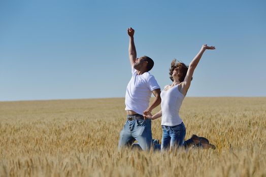 happy young couple in love have romance and fun at wheat field in summer