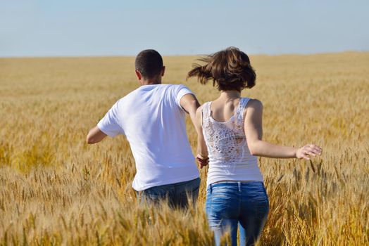 happy young couple in love have romance and fun at wheat field in summer