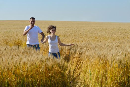 happy young couple in love have romance and fun at wheat field in summer