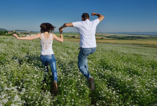 happy young couple in love have romance and fun at wheat field in summer