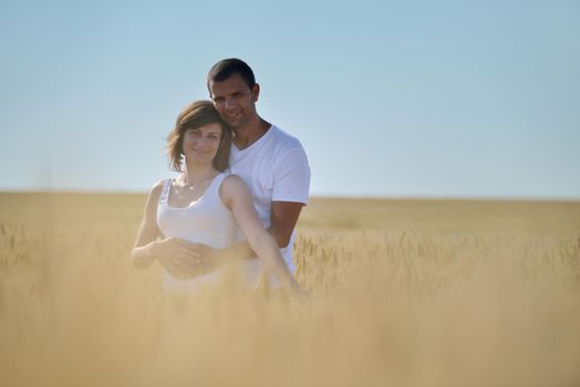 happy young couple in love have romance and fun at wheat field in summer