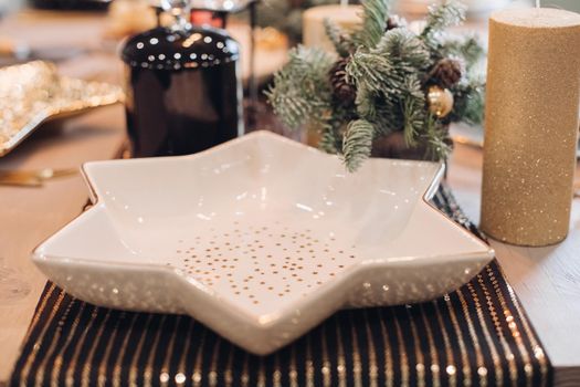 Serving table with festive dishes and candles. New Year eve concept